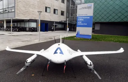 A white drone standing outside the NHS Clinical Sciences Building